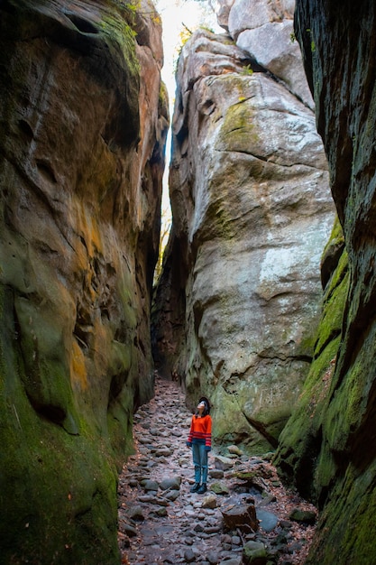 Woman traveler walking by trail in canyon