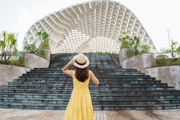 Woman Traveler with yellow dress visiting in Da Nang city Tourist sightseeing the city building Landmark and popular for tourist attraction Vietnam and Southeast Asia travel concept