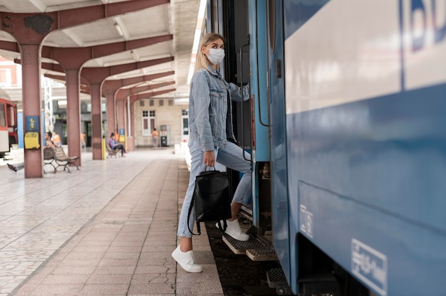 Woman traveling by train wearing medical mask for protection