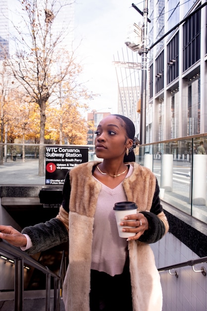 Woman traveling through city with her coffee