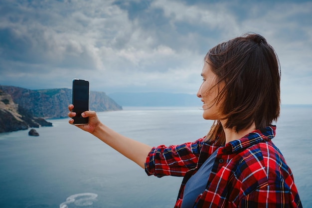 Woman traveling with backpack tourist on seashore in summer