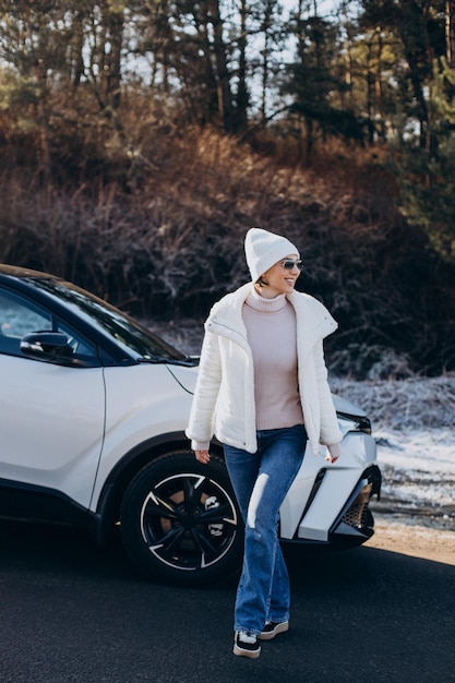 Woman travelling by car stopped by on the road