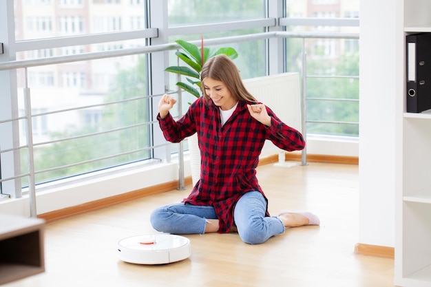 Woman turns on smart robot vacuum cleaner