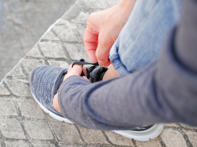 Woman tying shoe laces.Getting ready for jogging outdoors