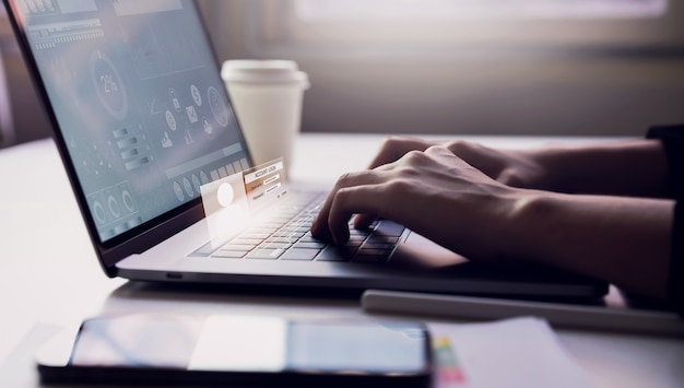 Woman typing keyboard laptop and account login screen on the working in the office on table background. Safety concepts about internet use.