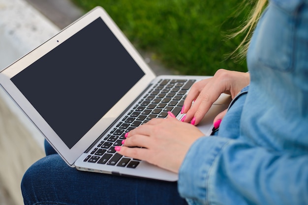 Woman typing laptop on legs