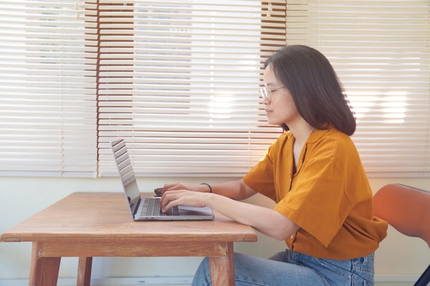 Woman typing and searching on computer at office person working on laptop concept