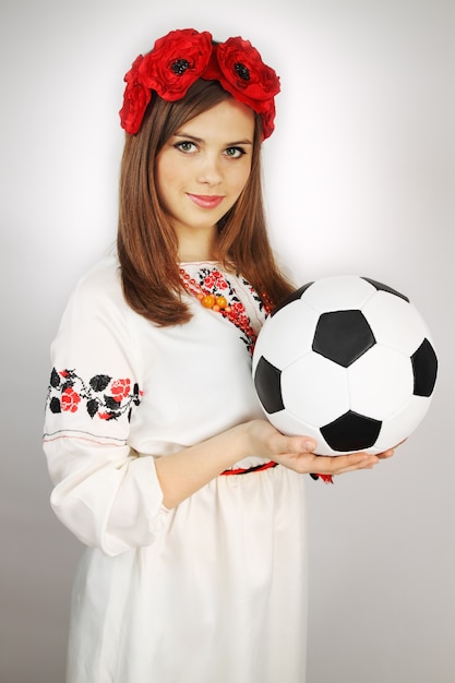 Woman in the Ukrainian suit holds the ball