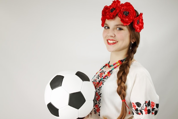 Woman in the Ukrainian suit holds the ball