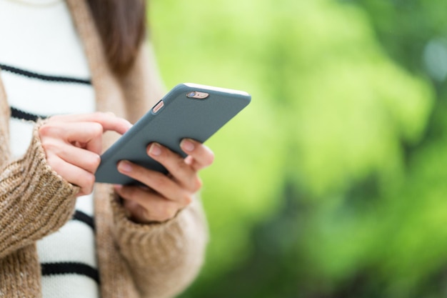 Woman use of mobile phone over green background