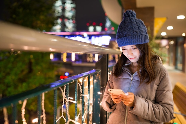 Woman use of mobile phone at night