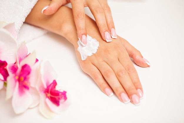 Woman use skin care products at home in light bathroom