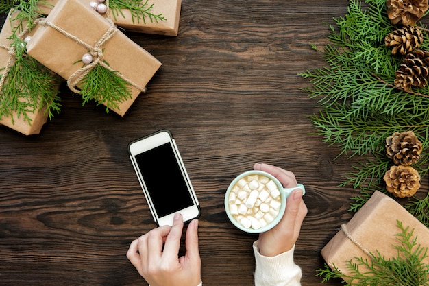 Woman use smartphone with copyspace on wood