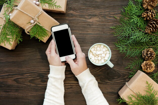 Woman use smartphone with copyspace on wood