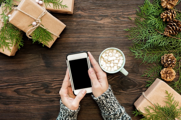 Woman use smartphone with copyspace on wood