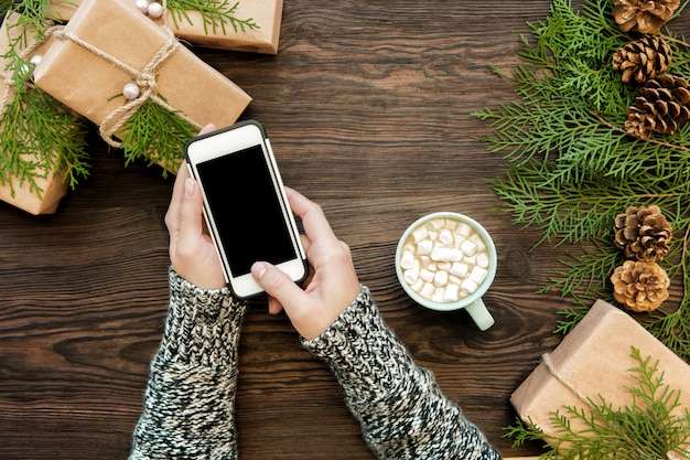 Woman use smartphone with copyspace on wood