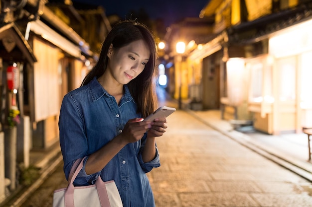 Woman using cellphone at night