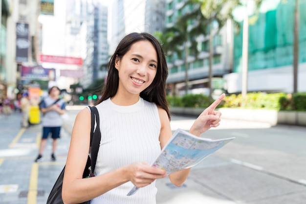 Woman using city map in Hong Kong