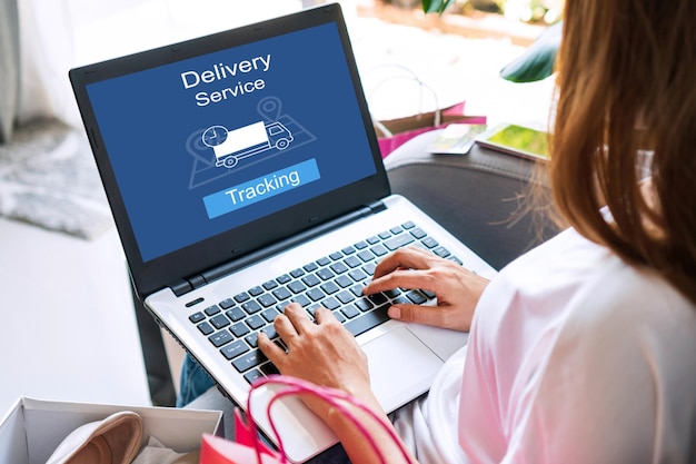 Woman using computer with app tracking parcel online to update status and delivery service status Online shopping Tracking delivery technology and lifestyle conceptx9