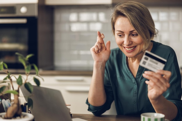 Woman Using Credit Card Online At Home