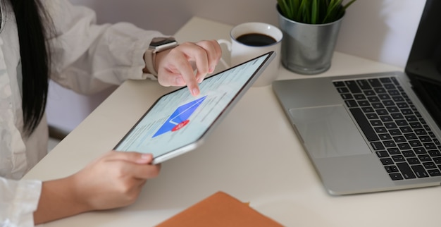 Woman using digital tablet for e-mail box checking in office