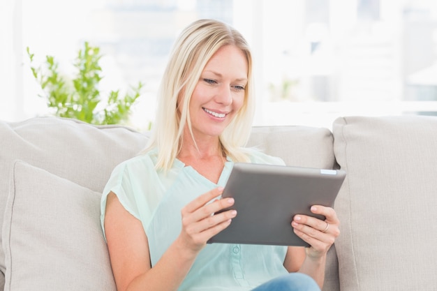 Woman using digital tablet at home