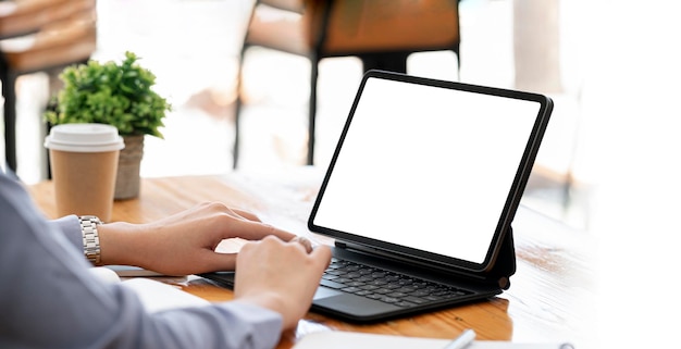 Woman using digital tablet at office mockup blank screen for product display or graphic design