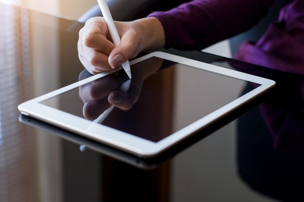 Woman using electronic pen work on digital tablet.