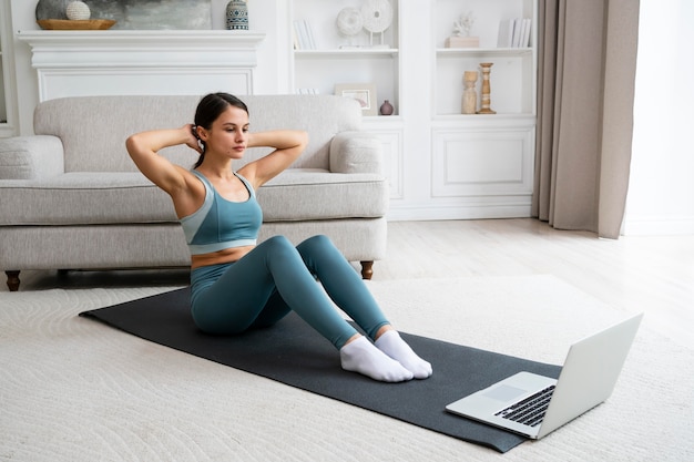 Woman using a fitness mat to workout