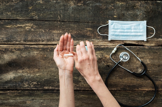 Woman using hand sanitizer to disinfect her hands