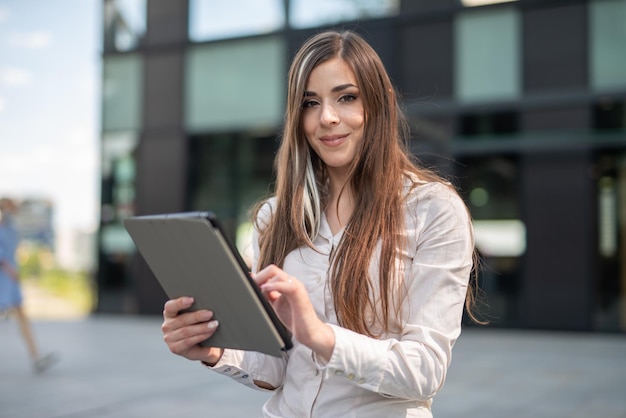 Woman using her tablet outdoor