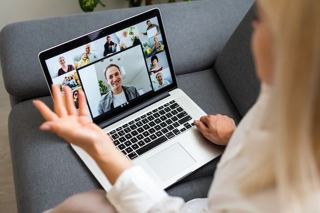 Woman using laptop indoor. woman listens to online lecture