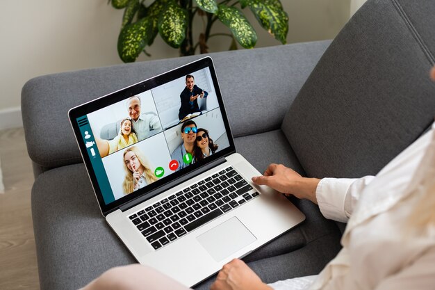 Woman using laptop indoor. woman listens to online lecture