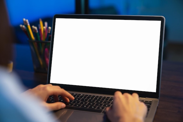 Woman using laptop with blank copy space screen for your advertisement. on the table in office.