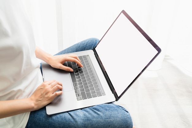 Woman using laptop with blank copy space screen for your advertisement.