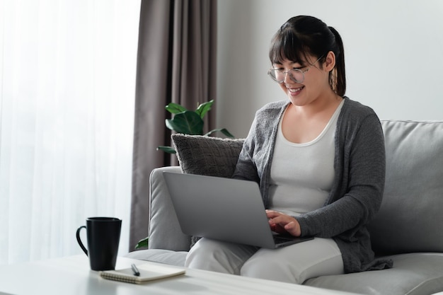 Woman using laptop working at home office or workplacexA