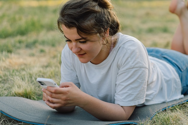 Woman using mobile phone the concept of lifestyle mobility and modern wireless communication technol...