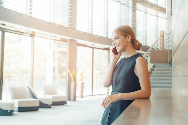 Woman using mobile phone in the office