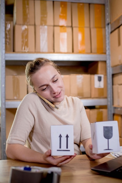 Photo woman using mobile phone or tablet to communicate with customers delivery of goods through private courier companies concepts of online sales and online stores