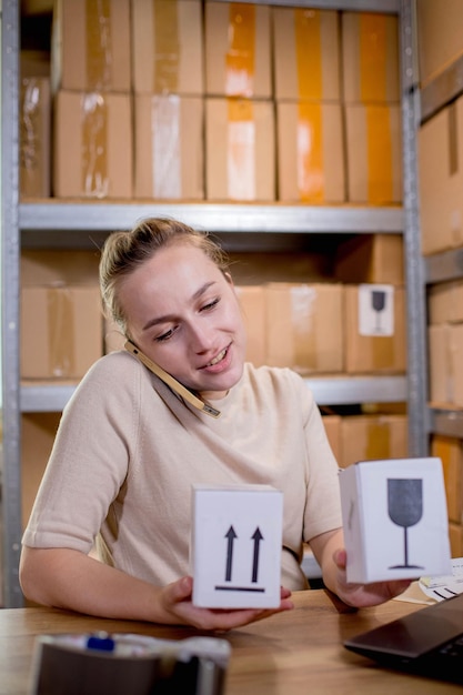 Woman using mobile phone or tablet to communicate with customers Delivery of goods through private courier companies Concepts of online sales and online stores