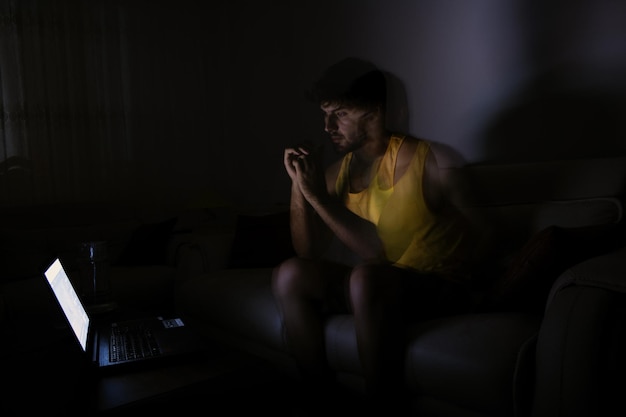 Woman using mobile phone while sitting on sofa at home