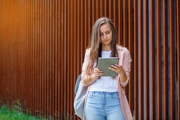 Woman using modern technology outside professional female manager reading information on tablet