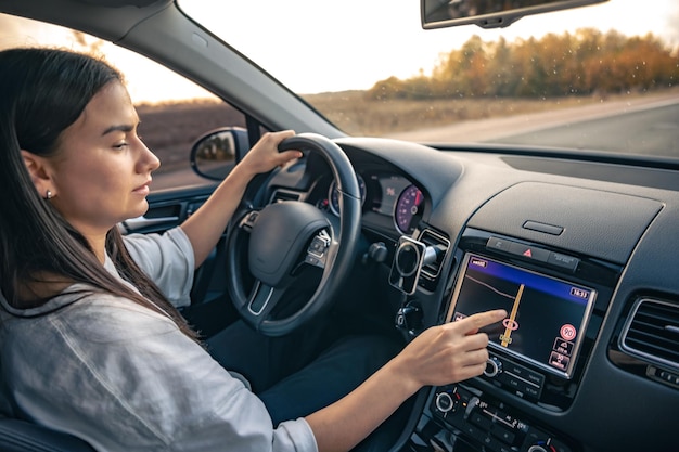 Woman using navigation system while driving a car