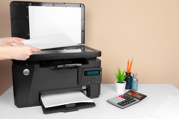 Woman using the printer to scanning and printing document