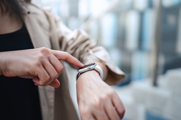 Woman using smart watches with checking pulse via health application