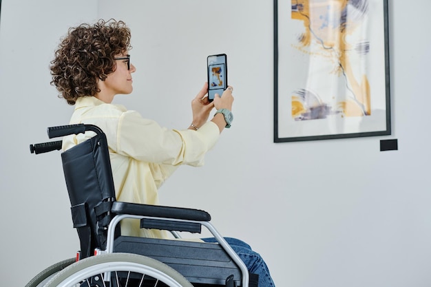 Woman using smartphone at art gallery