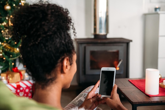 Woman using smartphone on Christmas