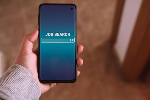 Woman using smartphone to find a job Find your career Online website on screen to search a job