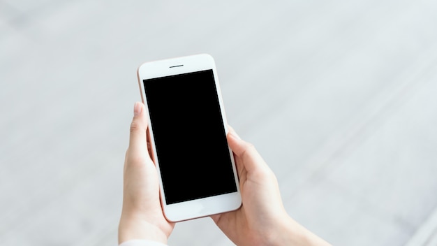 Woman using smartphone on staircase in public areas, During leisure time.