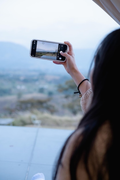 Woman using smartphone take a photo at Khao Kho Thailand